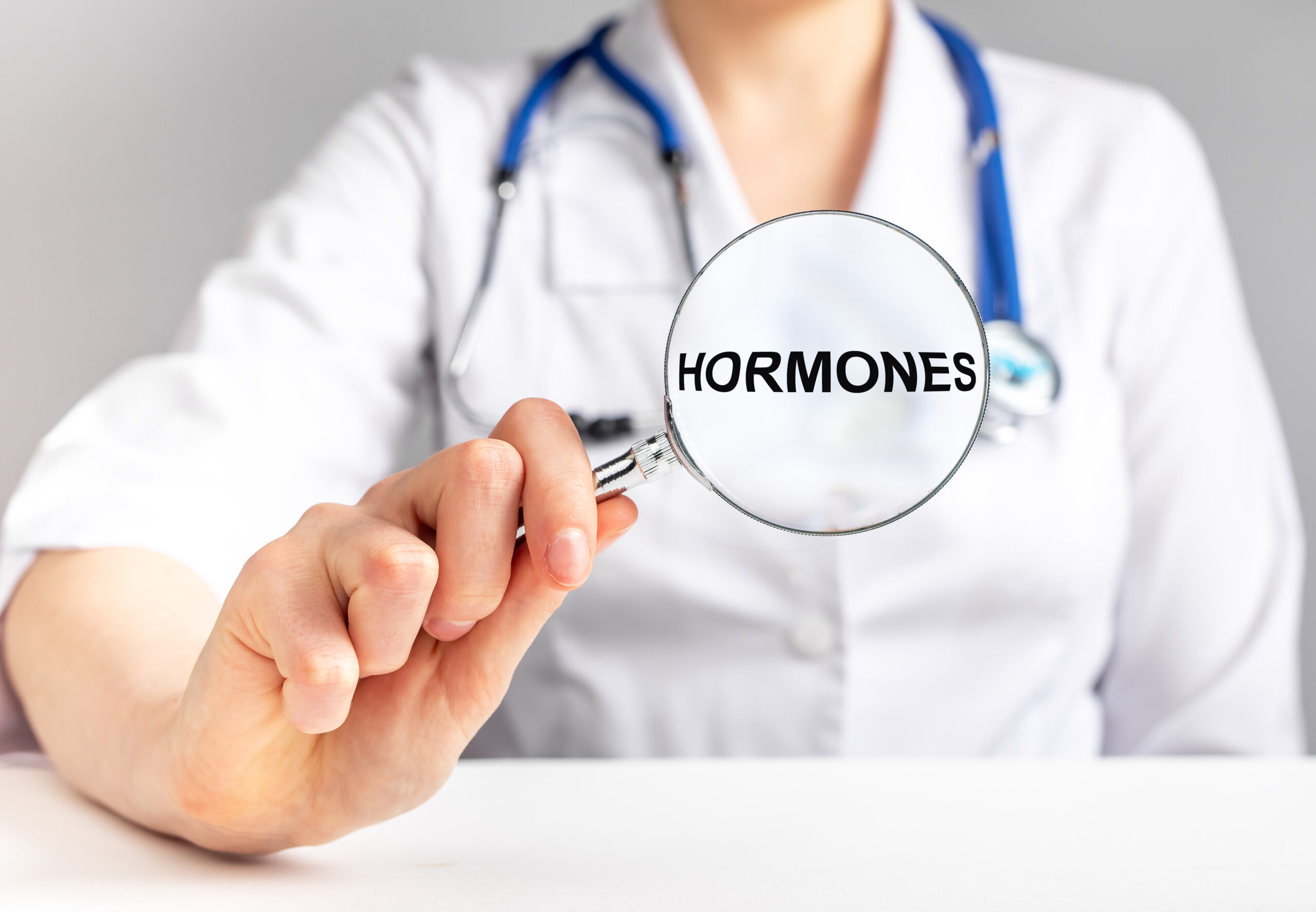 Doctor studying hormones concept. Magnifier with word. High quality photo